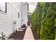 The house's side yard shows the greenery along the side of the house at 1610 N Alabama St, Indianapolis, IN 46202