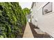 The side yard features greenery along the house and a walkway at 1610 N Alabama St, Indianapolis, IN 46202
