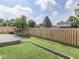 Backyard with a stained wood fence, swing seat, and mature trees overhead at 1645 Oakmere Way, Greenwood, IN 46142