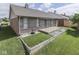 Brick house backyard with concrete patio, well-maintained lawn, and perimeter stone bed at 1645 Oakmere Way, Greenwood, IN 46142