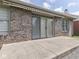 Brick house with backyard concrete patio and awning, as well as green lawn at 1645 Oakmere Way, Greenwood, IN 46142