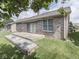 Brick house backyard featuring a concrete patio and well-maintained landscaping at 1645 Oakmere Way, Greenwood, IN 46142