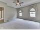 Bright bedroom with carpet and two windows with decorative window treatments at 1645 Oakmere Way, Greenwood, IN 46142