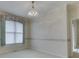 Bedroom with a decorative chandelier, large window, and cream carpet at 1645 Oakmere Way, Greenwood, IN 46142