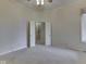 Neutral-toned bedroom featuring a closet with open double doors and carpeted floors at 1645 Oakmere Way, Greenwood, IN 46142