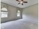 Large bedroom with carpet, two windows, and decorative window treatments at 1645 Oakmere Way, Greenwood, IN 46142