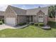 Charming brick home featuring a manicured lawn and landscaped garden beds at 1645 Oakmere Way, Greenwood, IN 46142