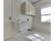 Simple laundry room with a utility sink, cabinets, and a window at 1645 Oakmere Way, Greenwood, IN 46142