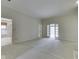 Spacious living room featuring plush carpet, with views to rear patio via glass paned doors at 1645 Oakmere Way, Greenwood, IN 46142