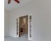 Bright living room featuring a ceiling fan and a fireplace in an adjacent room at 1645 Oakmere Way, Greenwood, IN 46142