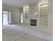 Inviting living room with built-in bookshelves, a cozy fireplace, and plush carpet at 1645 Oakmere Way, Greenwood, IN 46142