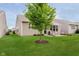 Expansive backyard featuring a healthy tree and a patio area with a retractable awning for outdoor relaxation at 16573 Grappa Trl, Fishers, IN 46037