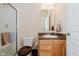 Bathroom with wood cabinets, single sink, toilet, and glass shower door at 16573 Grappa Trl, Fishers, IN 46037