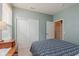 Bedroom featuring green walls, a patterned comforter, dresser, and closet doors at 16573 Grappa Trl, Fishers, IN 46037