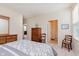 Bedroom with neutral walls, carpet, wood furniture, and doorway to another room at 16573 Grappa Trl, Fishers, IN 46037