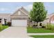 Charming brick and siding home featuring a two-car garage and well-maintained front yard at 16573 Grappa Trl, Fishers, IN 46037