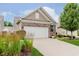 Charming home with a well-maintained front yard, two-car garage, and appealing brick and siding exterior at 16573 Grappa Trl, Fishers, IN 46037