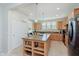Spacious kitchen island with pendant lighting, offering lots of prep surface and room for seating at 16573 Grappa Trl, Fishers, IN 46037