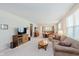 Inviting living room featuring neutral tones, plush carpeting, and abundant natural light at 16573 Grappa Trl, Fishers, IN 46037