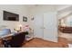 Home office with a view to another room, featuring a wood desk and shelves at 16573 Grappa Trl, Fishers, IN 46037