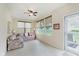 Bright sunroom with neutral walls, tile floor, floral sofa, and lots of light at 16573 Grappa Trl, Fishers, IN 46037