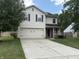 Two-story home with white siding, shutters, attached two-car garage, concrete driveway, and small front porch at 187 Broadmoor Bnd, Pittsboro, IN 46167