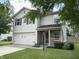 Two-story home with white siding, shutters, attached two-car garage, and small front porch and landscaping at 187 Broadmoor Bnd, Pittsboro, IN 46167