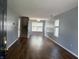 View of the open living room with wood floors, neutral paint, and staircase at 187 Broadmoor Bnd, Pittsboro, IN 46167