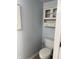 The powder room has a toilet, vanity and light blue walls at 187 Broadmoor Bnd, Pittsboro, IN 46167