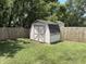 The shed with a garden, enclosed by a wooden fence and surrounded by lush greenery, offering privacy and storage at 187 Broadmoor Bnd, Pittsboro, IN 46167