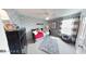 Cozy bedroom with a stylish dresser, rug, comfortable chair, and window with gray and white curtains at 19824 Atwater Ave, Sheridan, IN 46069
