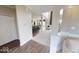 Open-concept living room with hardwood floors and plush carpet leading to a spacious kitchen and living area at 19824 Atwater Ave, Sheridan, IN 46069