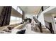 Bright, open living room with high ceilings, large windows, and elegant staircase at 19824 Atwater Ave, Sheridan, IN 46069