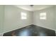 Comfortable bedroom with freshly painted walls, hardwood floors, and natural light through windows at 2035 W Kessler Blvd N Dr, Indianapolis, IN 46222