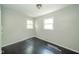 Cozy bedroom with hardwood floors, freshly painted walls, and natural light from windows at 2035 W Kessler Blvd N Dr, Indianapolis, IN 46222