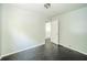 A bedroom featuring neutral walls, wood floor, a ceiling light, and a white closet door at 2035 W Kessler Blvd N Dr, Indianapolis, IN 46222