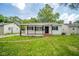 Exterior view of house with white siding, front porch with awning and red tiled entry at 2035 W Kessler Blvd N Dr, Indianapolis, IN 46222
