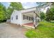 Side view of house with white siding, front porch with awning and red tiled entry at 2035 W Kessler Blvd N Dr, Indianapolis, IN 46222