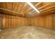 Empty garage with plywood walls, concrete floor and flourescent lighting at 2035 W Kessler Blvd N Dr, Indianapolis, IN 46222