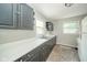 Functional kitchen with gray cabinets, white countertops, double sink, and natural lighting from two windows at 2035 W Kessler Blvd N Dr, Indianapolis, IN 46222