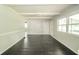 Sunlit living area features hardwood floors, neutral paint, and large windows offering a bright and inviting space at 2035 W Kessler Blvd N Dr, Indianapolis, IN 46222