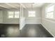 Open-concept living space features hardwood floors, decorative columns, and large windows for ample natural light at 2035 W Kessler Blvd N Dr, Indianapolis, IN 46222