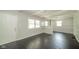 Inviting living space features wood floors, fresh paint, large windows, and a view into other rooms at 2035 W Kessler Blvd N Dr, Indianapolis, IN 46222