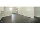 Bright living room with dark hardwood floors, white walls, and large windows that bring in lots of natural light at 2035 W Kessler Blvd N Dr, Indianapolis, IN 46222