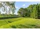 Expansive, well-manicured backyard featuring lush green grass and a secure fence, perfect for outdoor activities at 2320 Whispering Way, Indianapolis, IN 46239