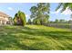 Large backyard offering ample space with mature trees, ideal for recreation and outdoor enjoyment at 2320 Whispering Way, Indianapolis, IN 46239