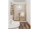 Bathroom featuring a toilet, shower with gold trim, and a rack with rolled towels at 2320 Whispering Way, Indianapolis, IN 46239