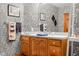 Bathroom with decorative wallpaper, a vessel sink, and wood cabinets at 2320 Whispering Way, Indianapolis, IN 46239