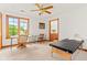 Spacious bedroom with a desk area, a massage table, and an ensuite bathroom at 2320 Whispering Way, Indianapolis, IN 46239
