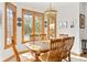 Bright dining room area with a large window view to the outdoor pool and lush yard at 2320 Whispering Way, Indianapolis, IN 46239
